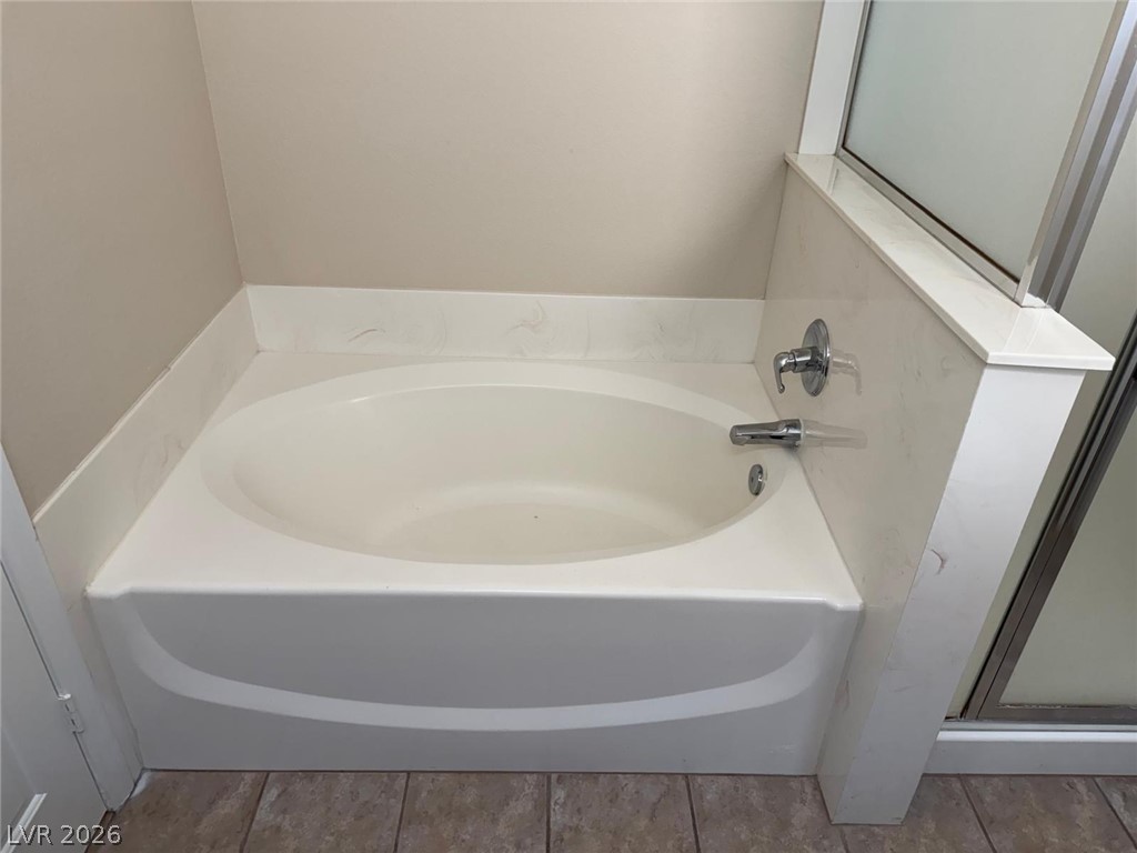 3962 Coyote Ridge Court Las Vegas, NV 89129 - Photo 17 of 35 A deep soaking tub awaits in this thoughtfully appointed bathroom, perfect for unwinding.