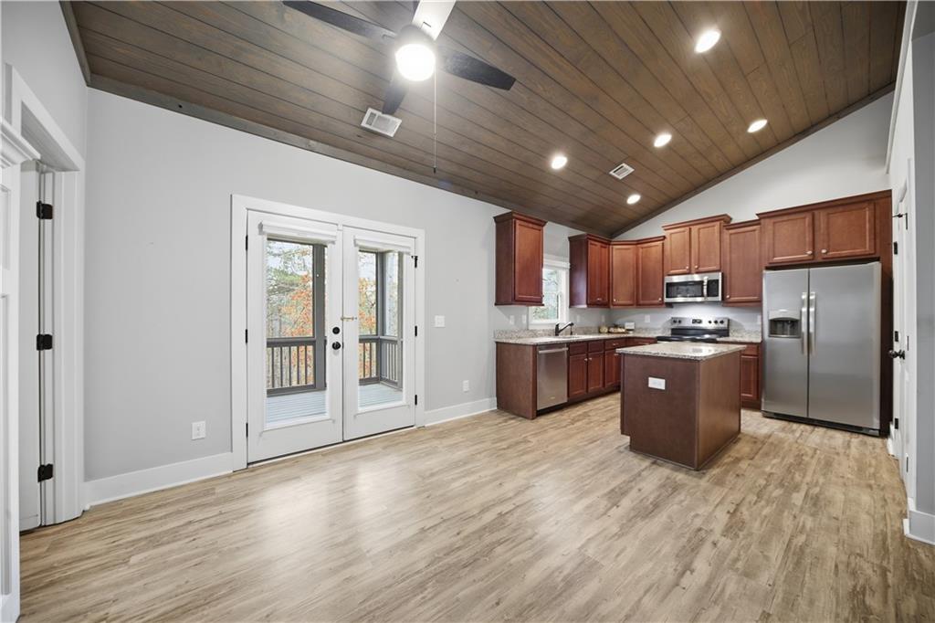 294 Town Creek Road Talking Rock, GA 30175 - Photo 12 of 68 a kitchen with stainless steel appliances granite countertop a refrigerator a sink dishwasher a stove and a refrigerator with wooden floor