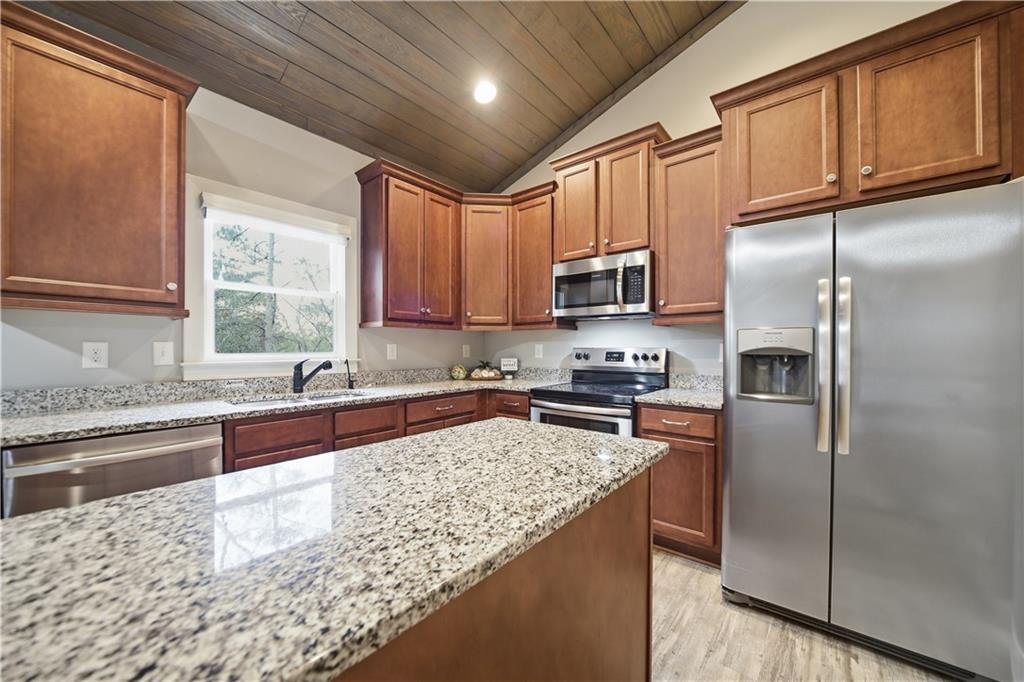 294 Town Creek Road Talking Rock, GA 30175 - Photo 14 of 68 a kitchen with stainless steel appliances granite countertop a refrigerator a sink dishwasher a stove top oven a refrigerator and cabinets