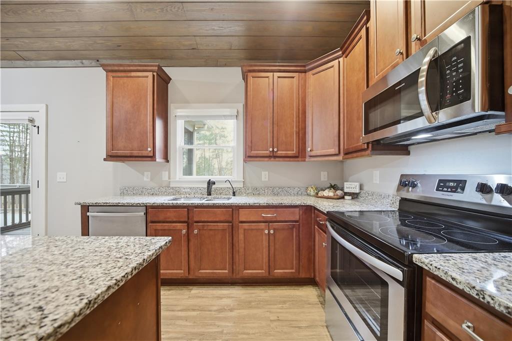 294 Town Creek Road Talking Rock, GA 30175 - Photo 15 of 68 a kitchen with stainless steel appliances granite countertop a sink stove and cabinets