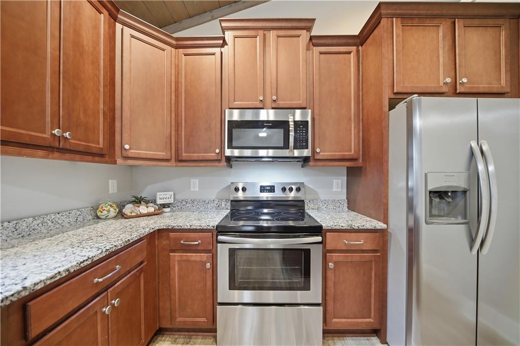 294 Town Creek Road Talking Rock, GA 30175 - Photo 16 of 68 a kitchen with granite countertop a stove top oven microwave and refrigerator
