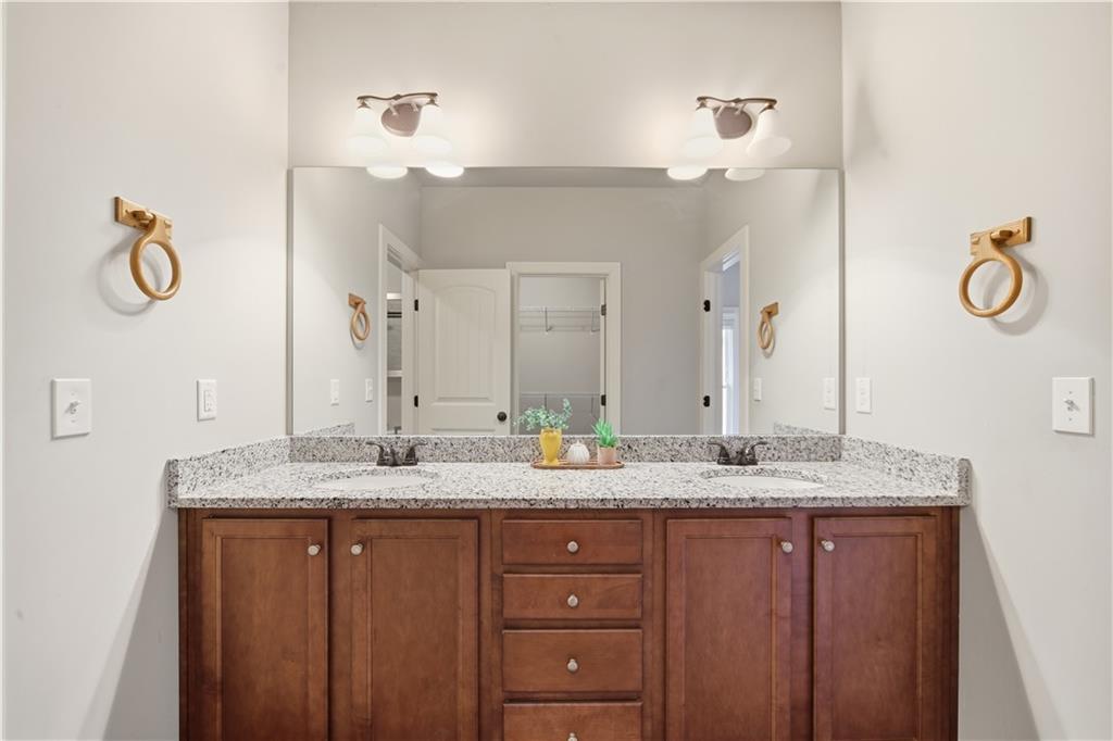294 Town Creek Road Talking Rock, GA 30175 - Photo 25 of 68 a bathroom with a granite countertop double vanity sink and a mirror