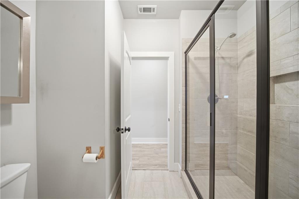 294 Town Creek Road Talking Rock, GA 30175 - Photo 26 of 68 a bathroom with a glass shower door