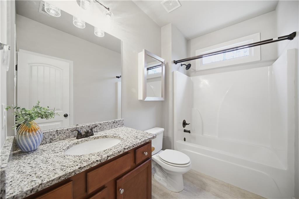 294 Town Creek Road Talking Rock, GA 30175 - Photo 30 of 68 a bathroom with a granite countertop sink toilet and shower