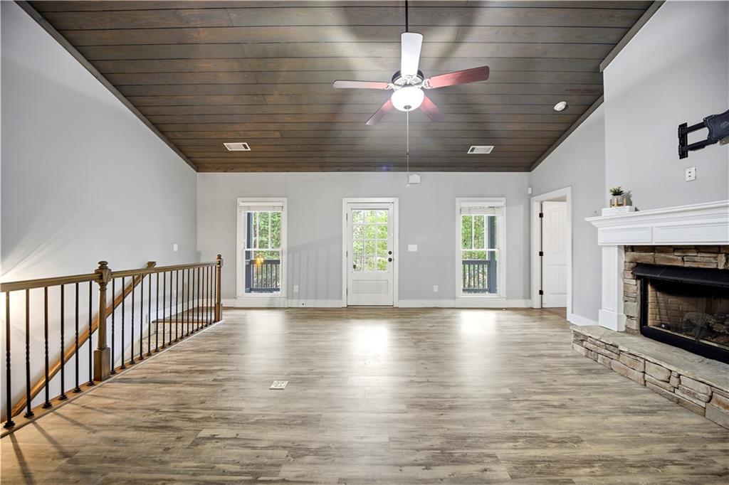 294 Town Creek Road Talking Rock, GA 30175 - Photo 6 of 68 a view of an empty room with wooden floor and a fireplace