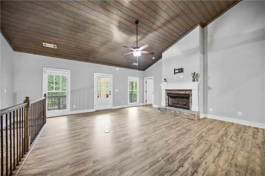 294 Town Creek Road Talking Rock, GA 30175 - Photo 10 of 68 an empty room with windows fireplace and a kitchen view