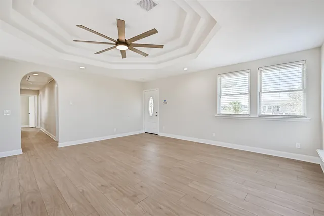 wooden floor in an empty room with a window
