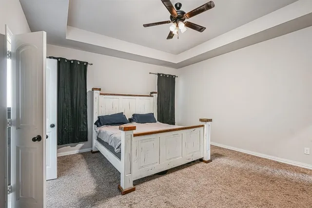 a bedroom with a bed and ceiling fan