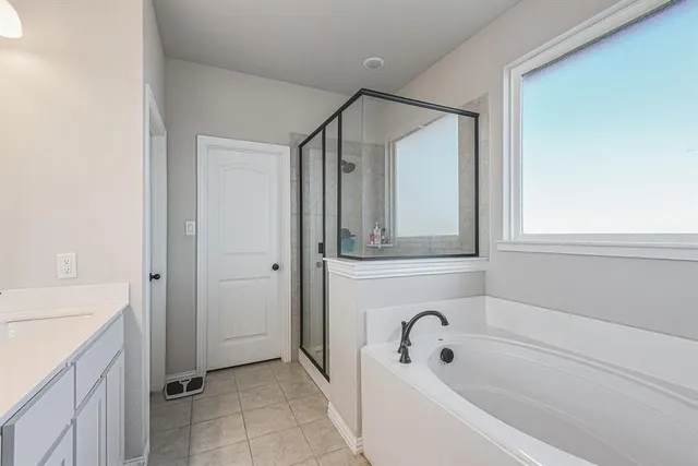a bathroom with a bathtub and a sink