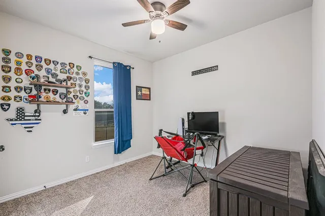 a workspace with furniture and a chandelier fan