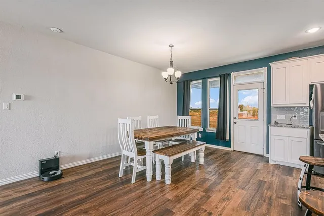 a living room with furniture a dining table and a wooden floor