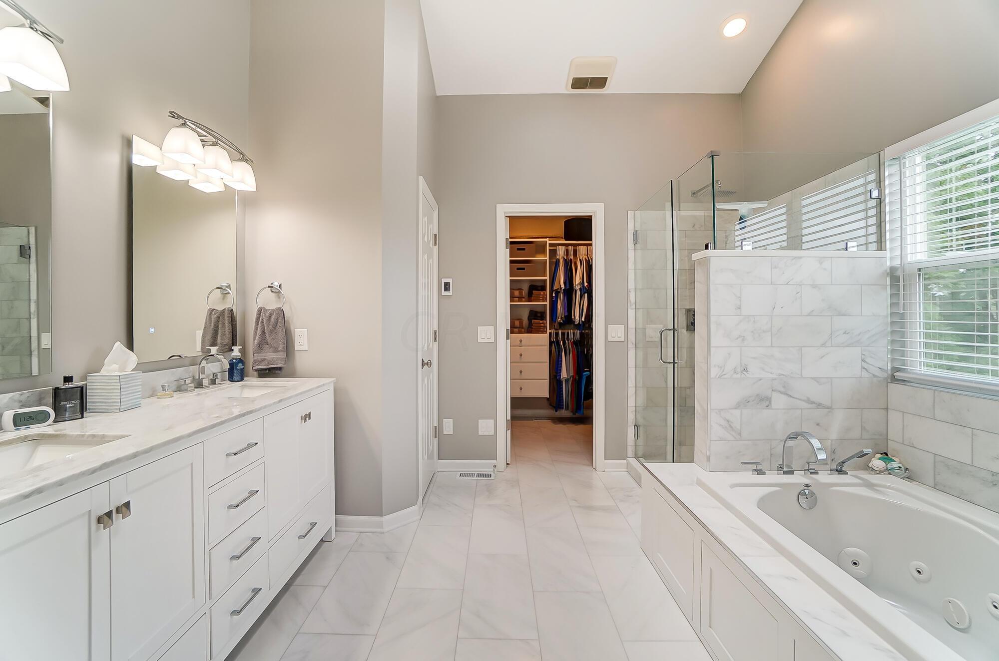 5674 Steward Road Galena, OH 43021 - Photo 51 of 82 Luxury at it's finest! Heated flooring, new tiles, vanity, sinks, fixtures, lighted mirrors, new toilets, new whirlpool tub, seperate toilet room & new window