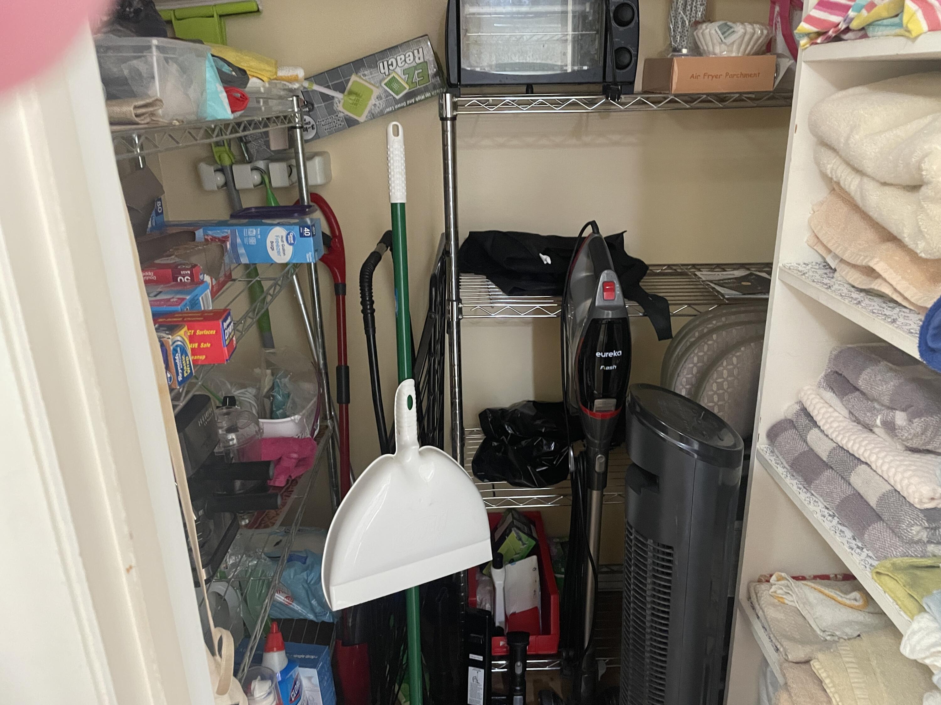 183 Dorchester East, Unit H West Palm Beach, FL 33417 - Photo 14 of 28 a view of walk in closet with clothes and shoes