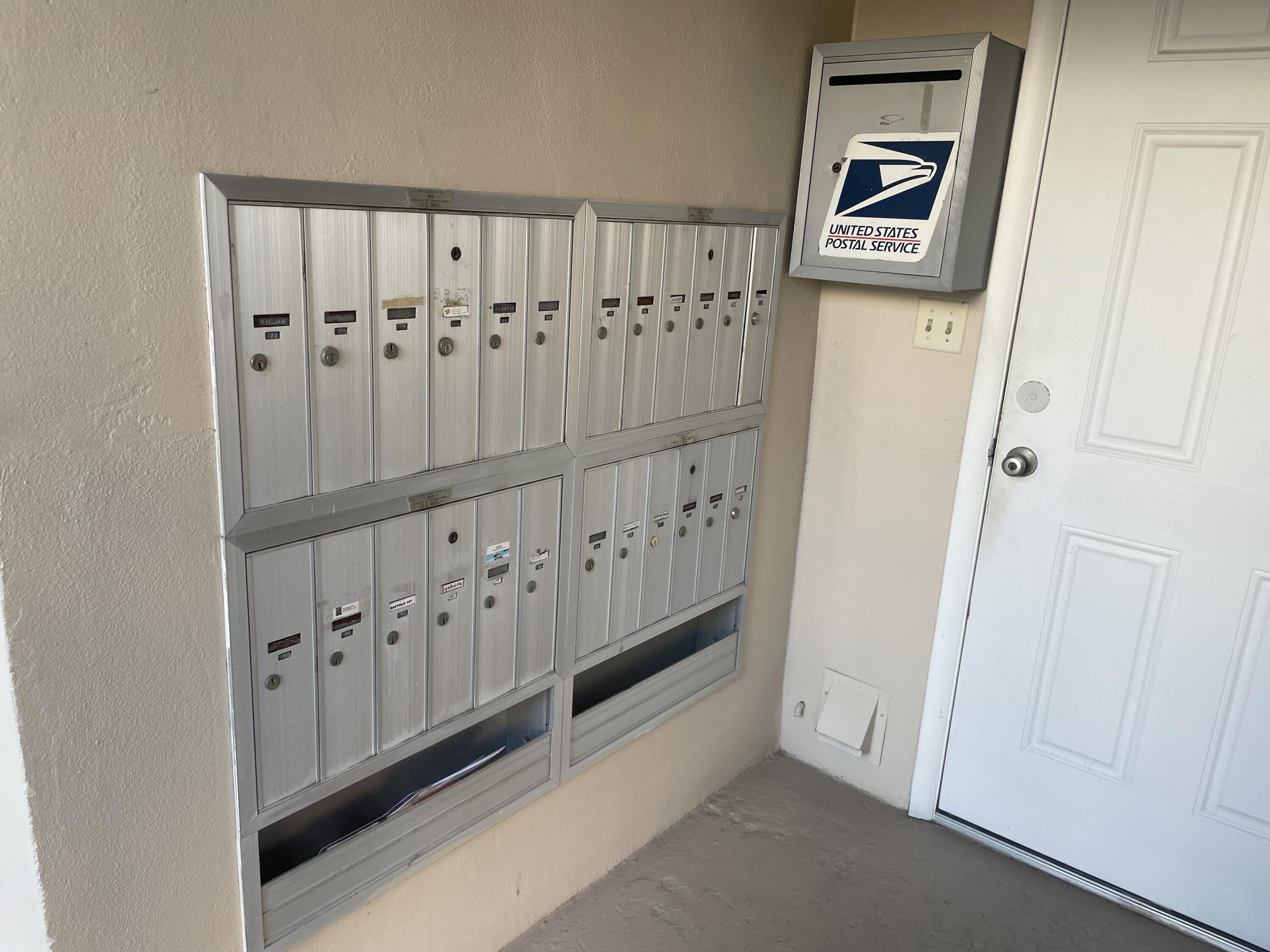 183 Dorchester East, Unit H West Palm Beach, FL 33417 - Photo 17 of 28 a view of a hallway with wooden shelves
