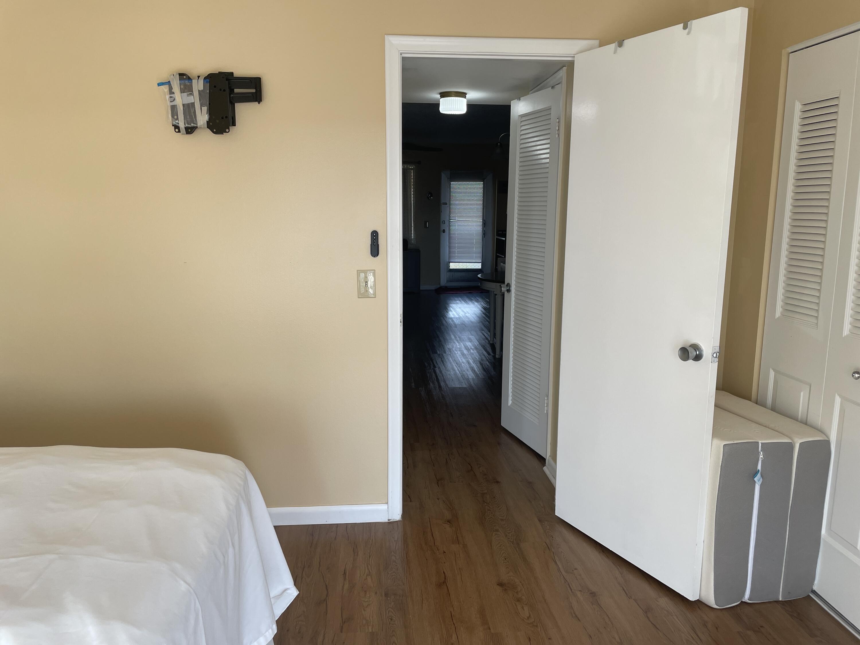 183 Dorchester East, Unit H West Palm Beach, FL 33417 - Photo 24 of 28 a view of a hallway with wooden floor