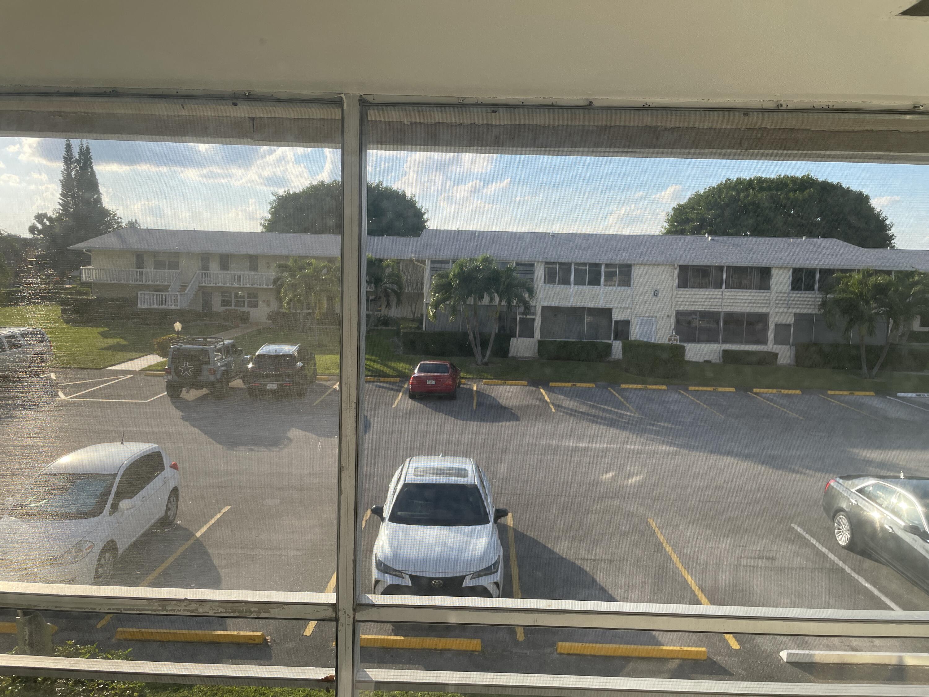 183 Dorchester East, Unit H West Palm Beach, FL 33417 - Photo 28 of 28 a view of a building from a window