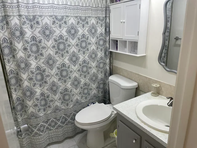a bathroom with a sink toilet and shower