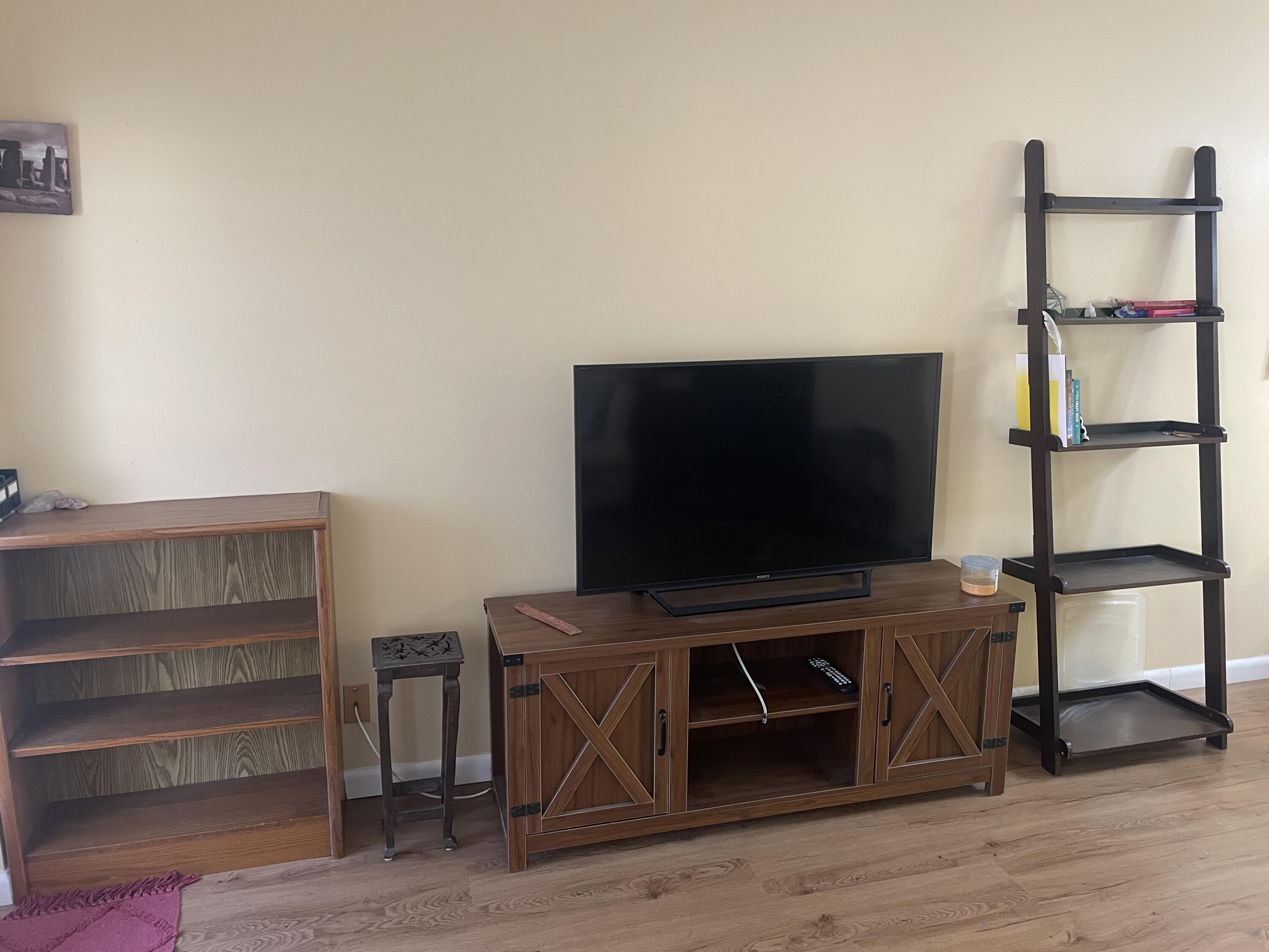 183 Dorchester East, Unit H West Palm Beach, FL 33417 - Photo 10 of 28 a living room with a flat screen tv and furniture