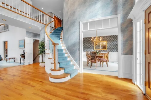 a view of entryway and hall with wooden floor