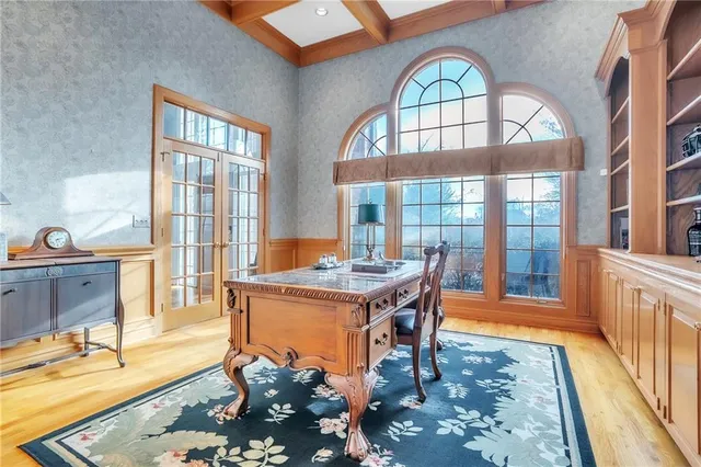 a view of a livingroom with furniture wooden floor and a floor to ceiling window