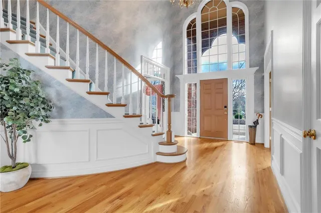 a view of an entryway with wooden floor and stairs