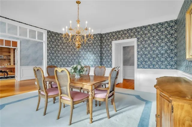 a view of a dining room with furniture and chandelier