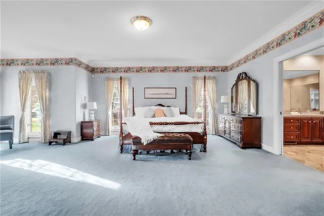 a bedroom with furniture and a chandelier