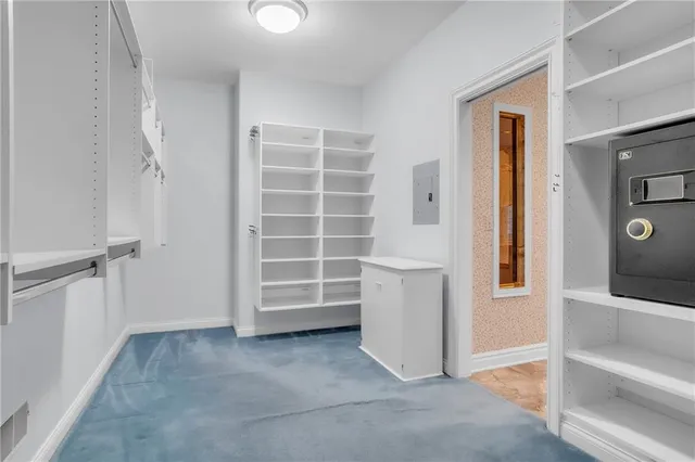 a view of an empty room with a cabinet and a window