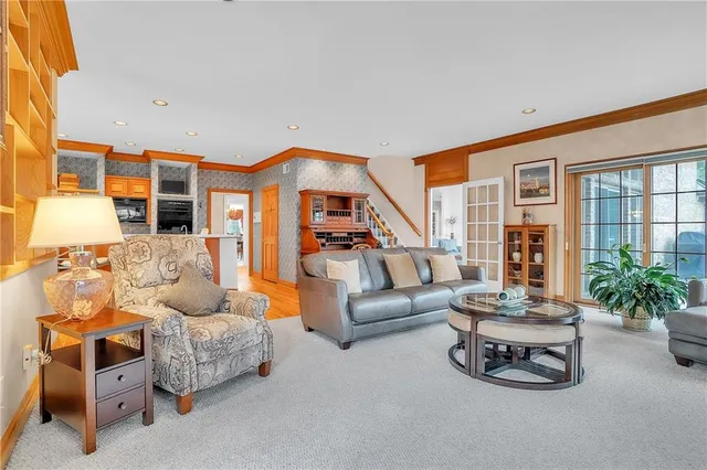 a living room with furniture fireplace and a large window
