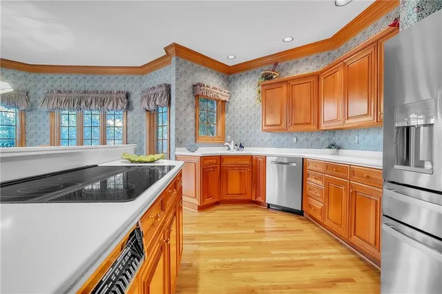 a kitchen with stainless steel appliances granite countertop a sink and cabinets