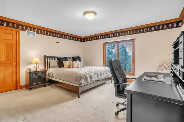 a bedroom with a bed a desk and chair