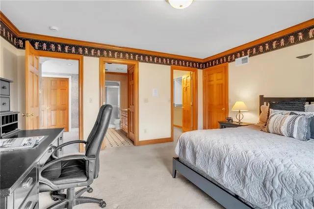 a bedroom with a bed and a desk