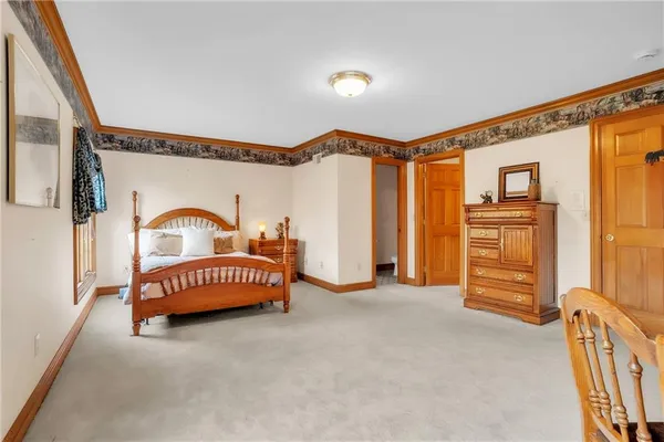 a bedroom with a bed next to a window