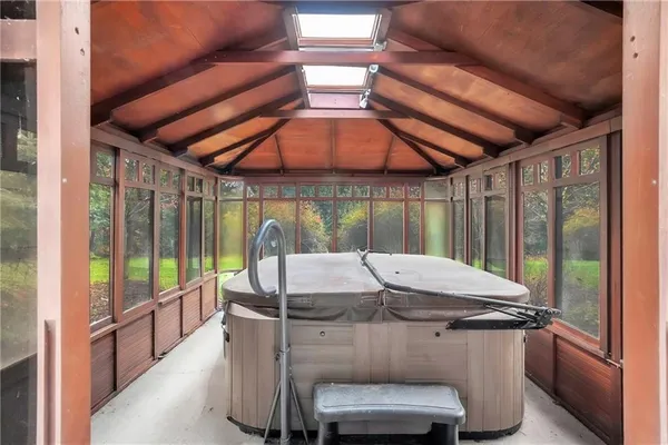 a view of a patio with table and chairs under an umbrella with a small yard