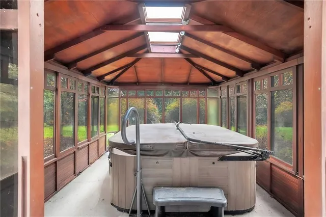 a view of a patio with table and chairs under an umbrella with a small yard