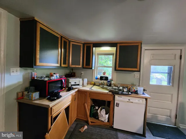 a kitchen with sink a cabinets and appliances