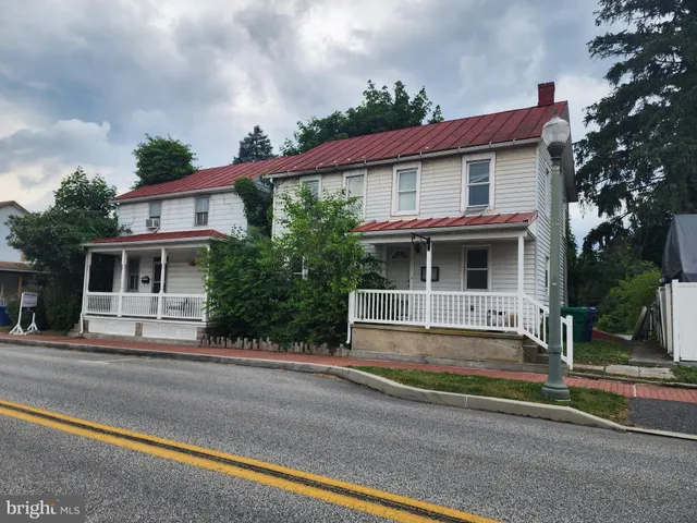 a view of street along with house and trees