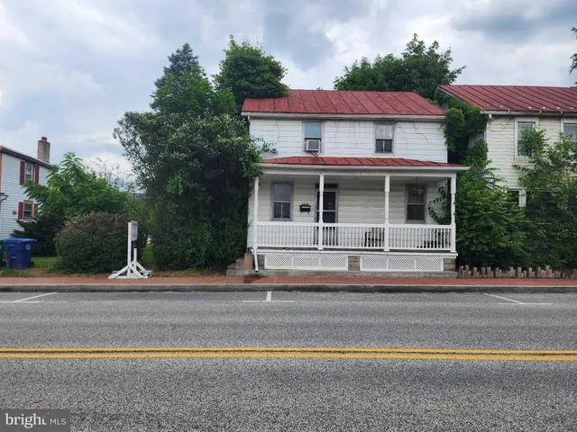 a view of street along with house and trees
