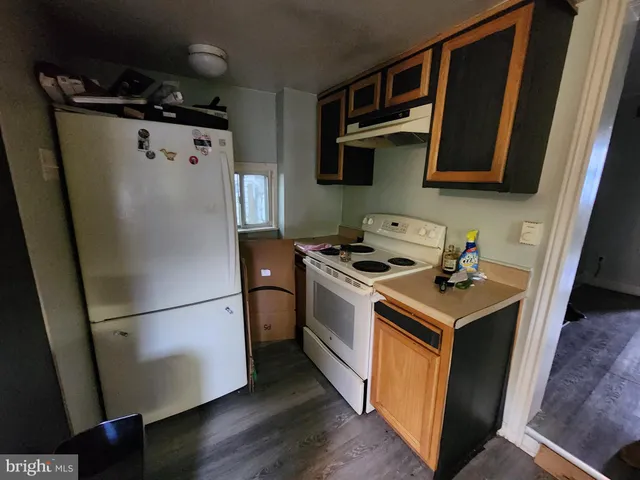 a kitchen with stainless steel appliances a refrigerator a sink and a stove