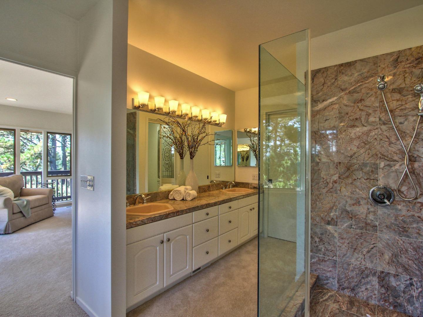 4130 Sunridge Road Pebble Beach, CA 93953 - Photo 19 of 31 a bathroom with a double vanity sink and mirror