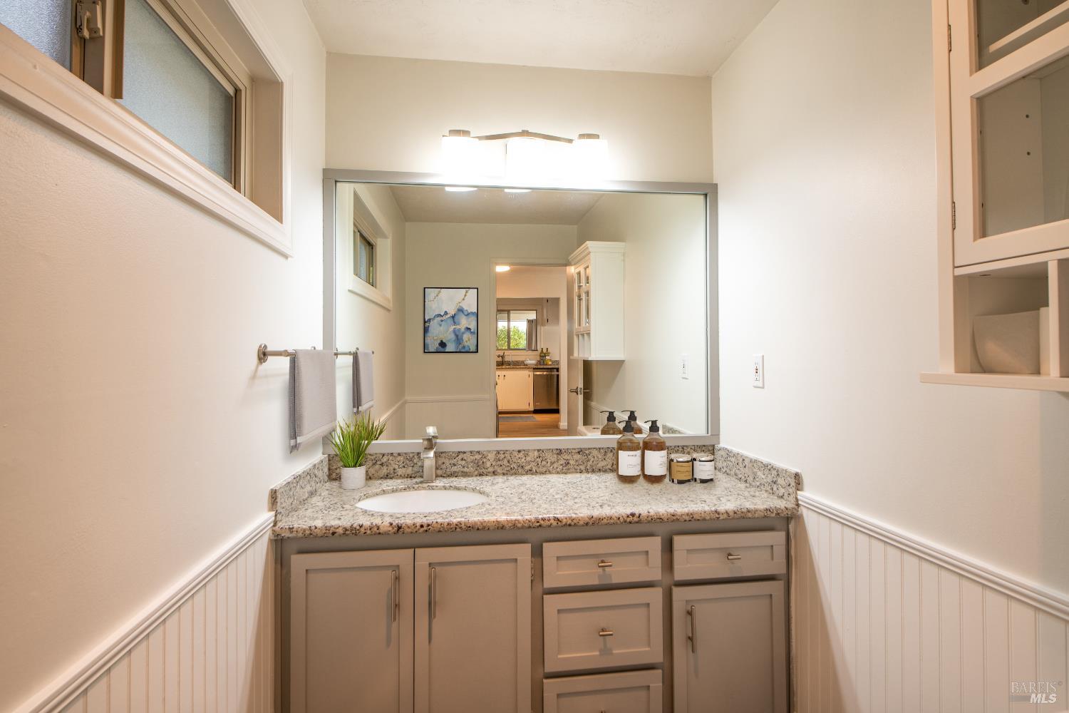 50 Vía Belardo, Unit 12 Greenbrae, CA 94904 - Photo 10 of 13 a bathroom with a granite countertop sink and a mirror