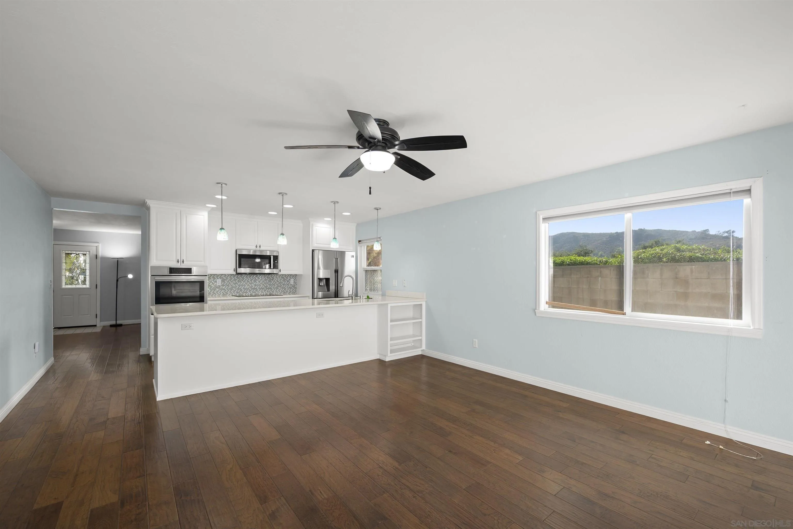 12679 Ridgeton Drive Lakeside, CA 92040 - Photo 16 of 33 a view of a kitchen with wooden floor and a ceiling fan