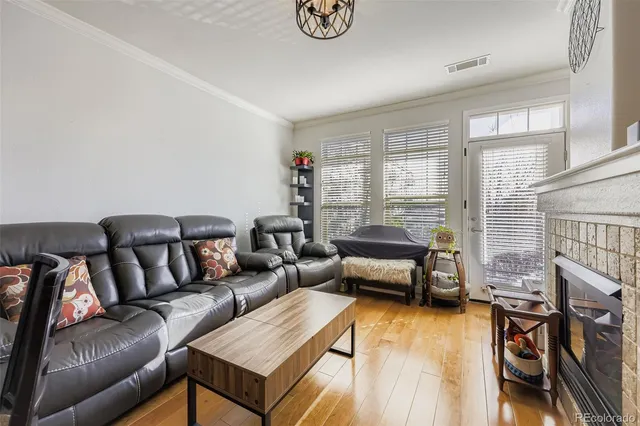 a living room with furniture and a floor to ceiling window