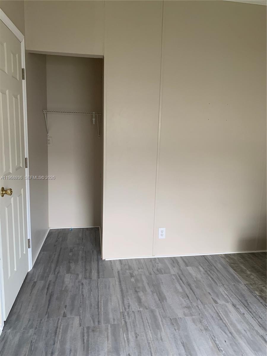 Watergate Boca Raton, FL 33428 - Photo 12 of 19 an empty room with wooden floor and windows