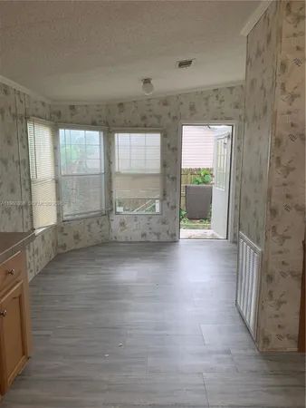 a view of wooden floor and brick walls