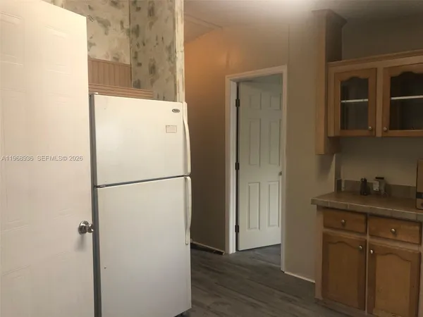 a white refrigerator freezer sitting inside of a kitchen