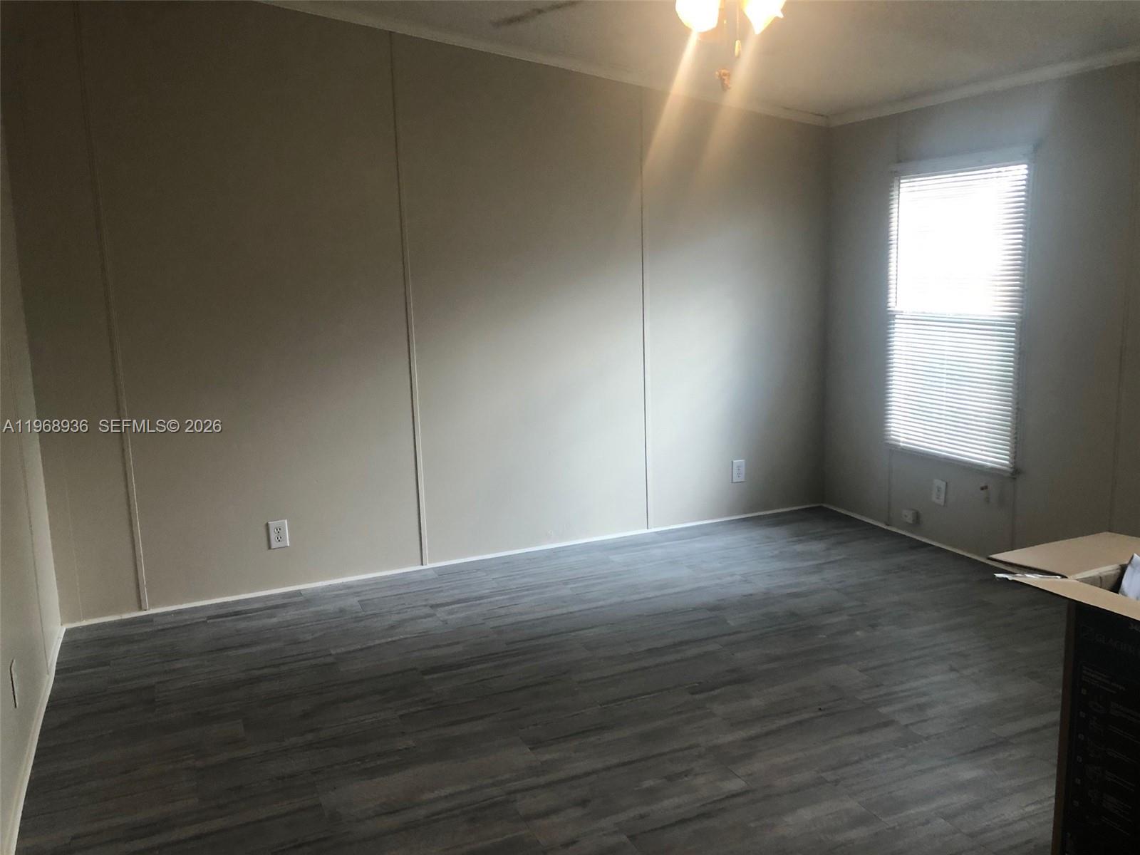 Watergate Boca Raton, FL 33428 - Photo 17 of 19 an empty room with wooden floor and windows