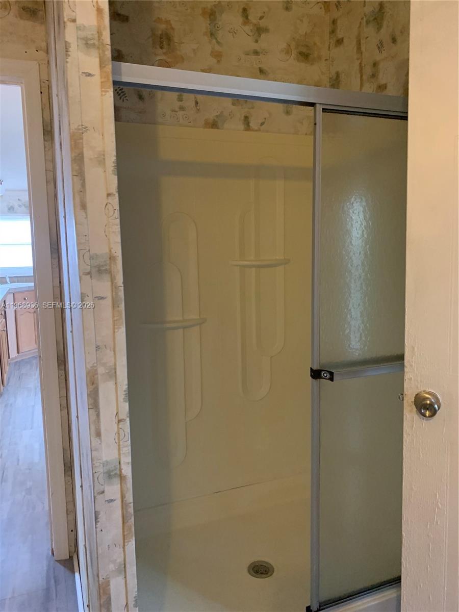 Watergate Boca Raton, FL 33428 - Photo 7 of 19 a bathroom with a glass shower door