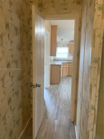 a bathroom with a wooden floor and a mirror