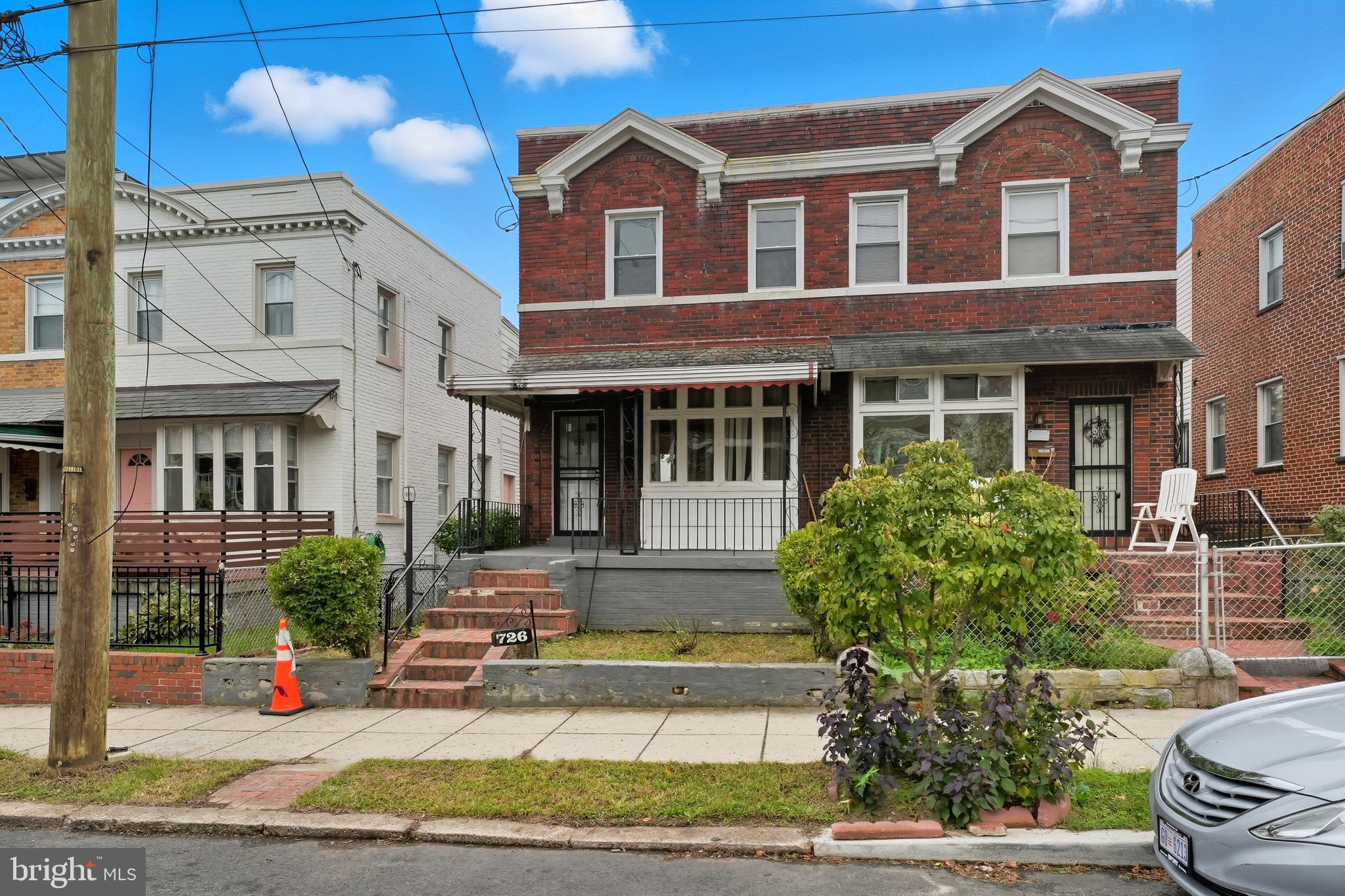 726 Somerset Place Northwest Washington, DC 20011 - Photo 1 of 28 a view of a white house with large windows and a table and chairs